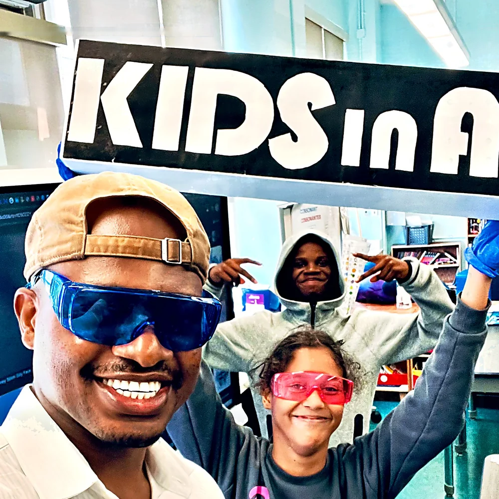 Students in safety goggles with an instructor